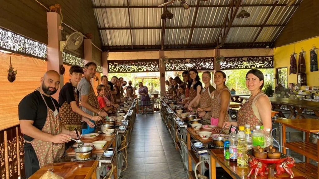 Tourists learning to cook Thai dishes at Siam Garden Cooking School in Chiang Mai