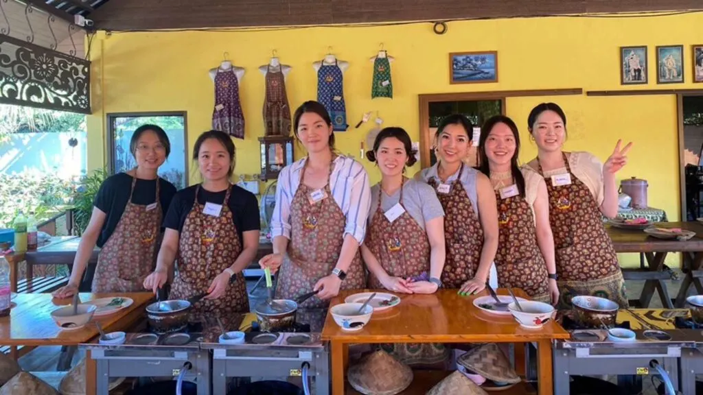 Tour group enjoying a cooking class at Cooking School in Chiang Mai