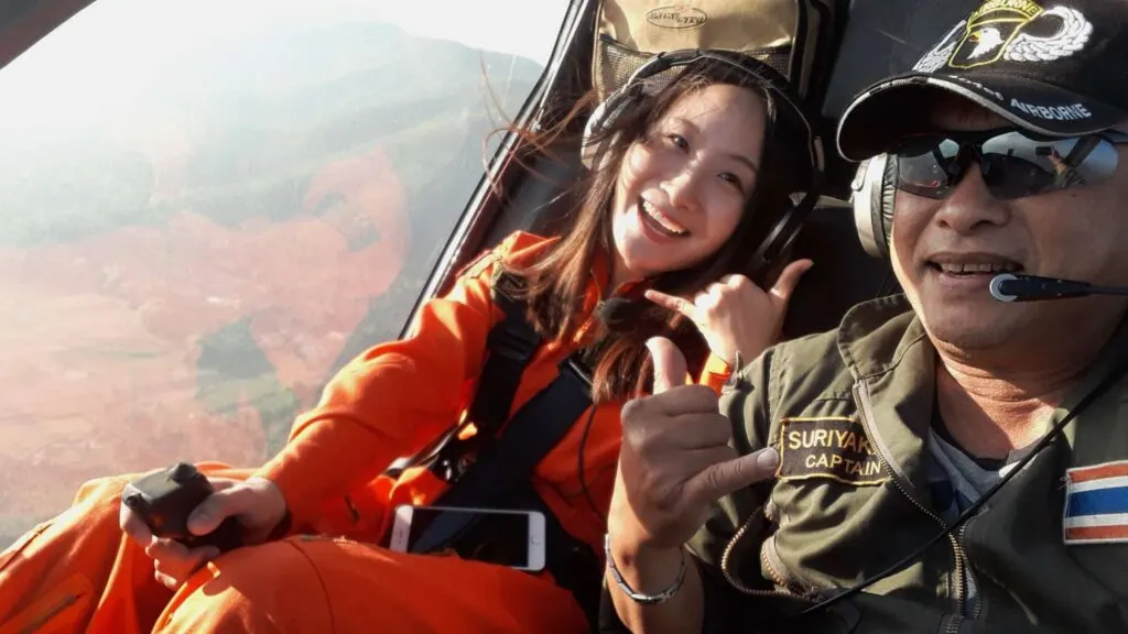 Happy passenger and pilot during a scenic flight over Chiang Mai, a highlight of our unique Chiang Mai tour packages.