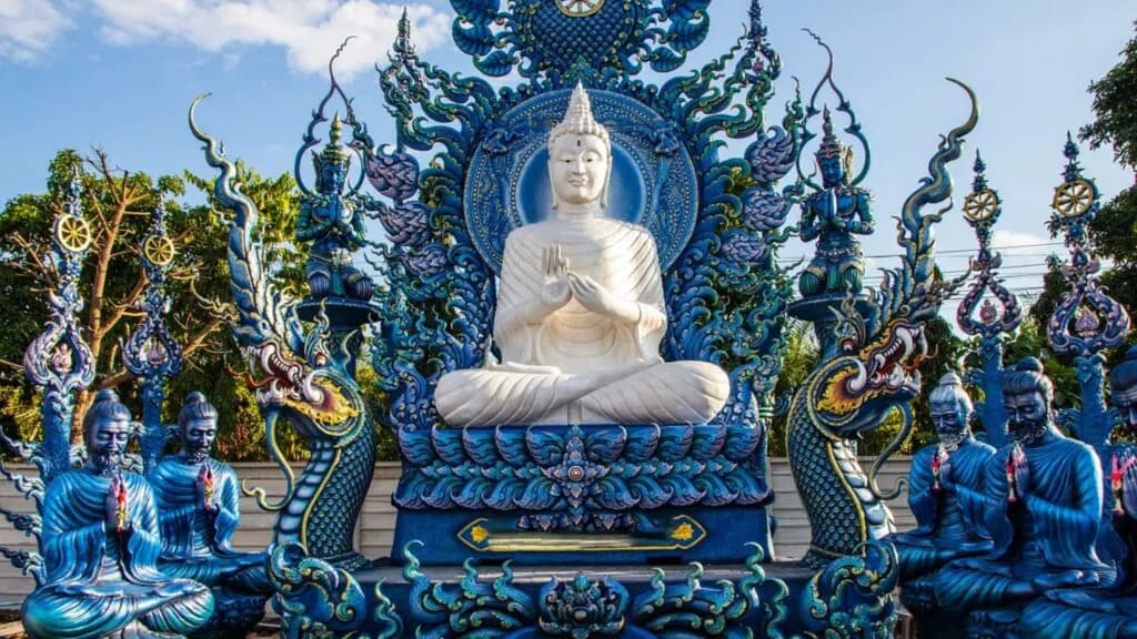 Magnificent white Buddha statue at Chiang Rai’s Blue Temple, featured in top Chiang Rai tours and temple excursions.