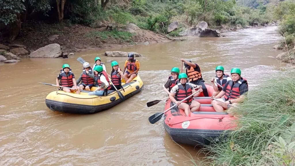 Group of tourists enjoying a fun day on the river with two rafting boats, experiencing the excitement of Chiang Mai excursions in the great outdoors