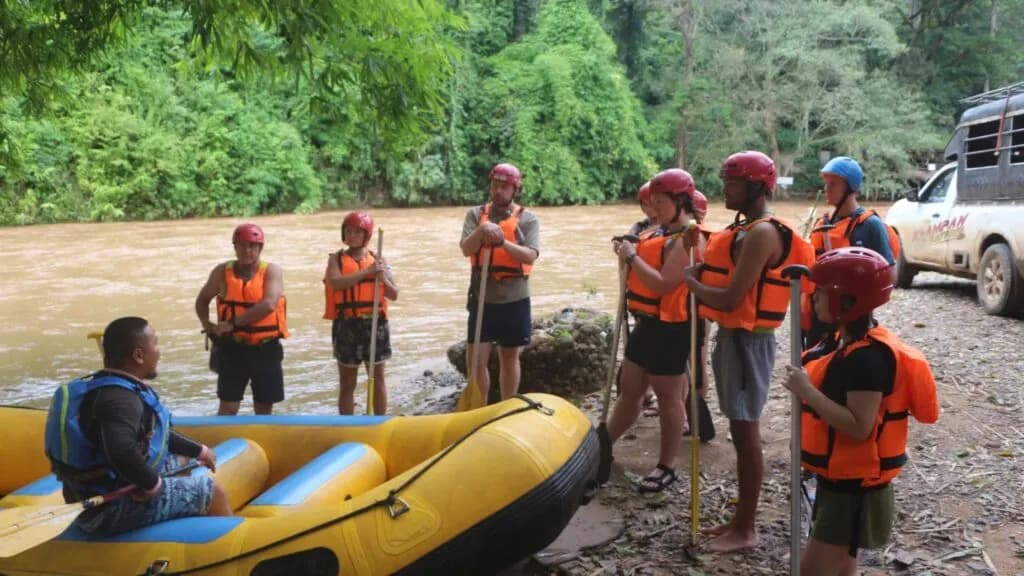 Rafting guide teaching safety tips to travelers during a Chiang Mai excursion