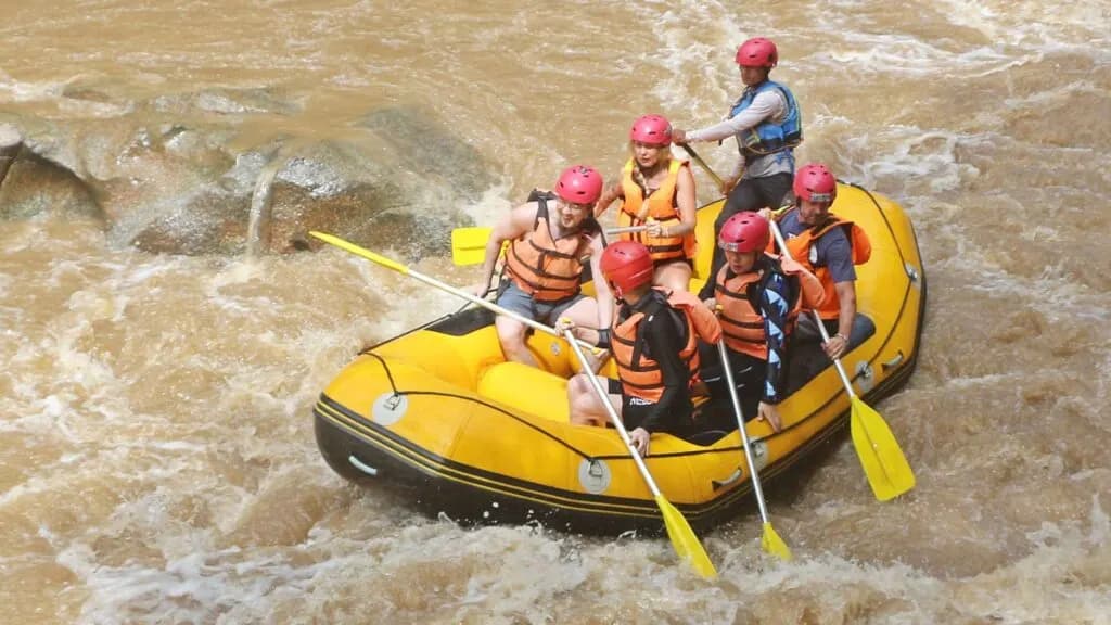 Travelers navigating the white water rapids on a Chiang Mai tour