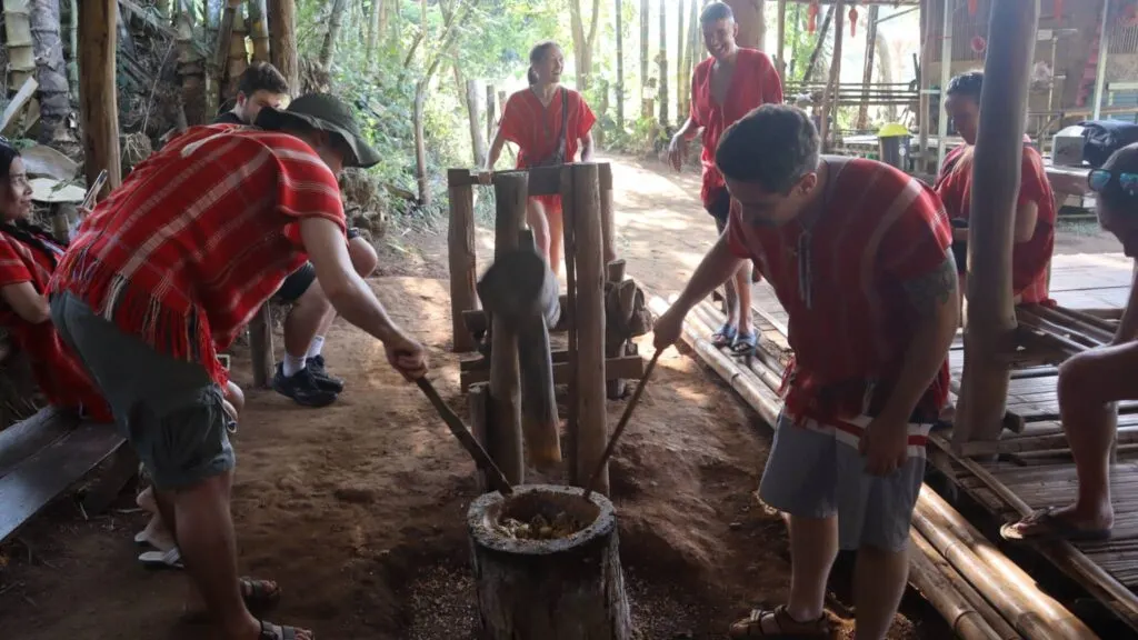 Participants preparing elephant medicine using traditional methods on a Chiang Mai excursion