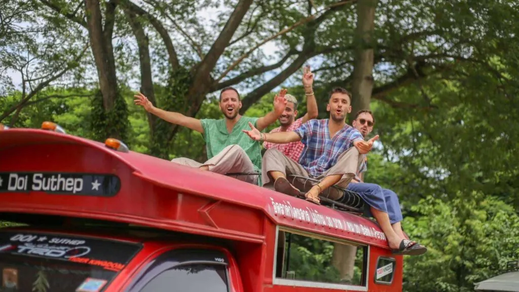 Visitors enjoying a photoshoot on top of a red car at Maerim Elephant Sanctuary during a Chiang Mai ethical elephant experience tour.