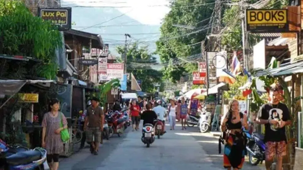 Tourists browsing through shops and enjoying the relaxed vibe of this northern Thai town.
