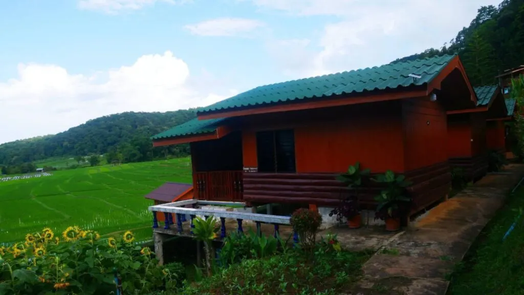 Traditional Karen village houses surrounded by rice fields on Doi Inthanon trekking tour from Chiang Mai