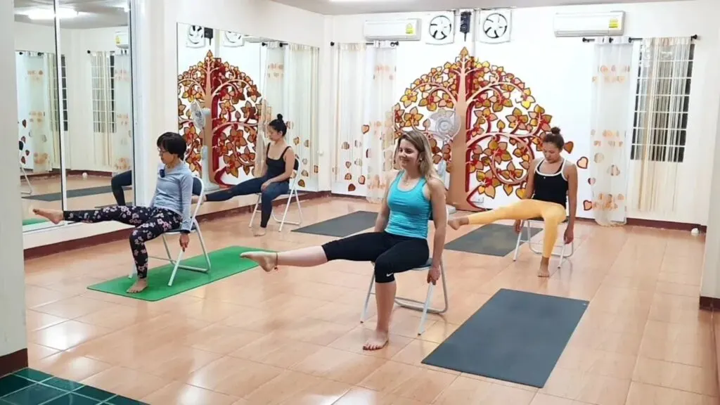 Small group practicing yoga and mindfulness outdoors during a Chiang Mai yoga and meditation retreat.