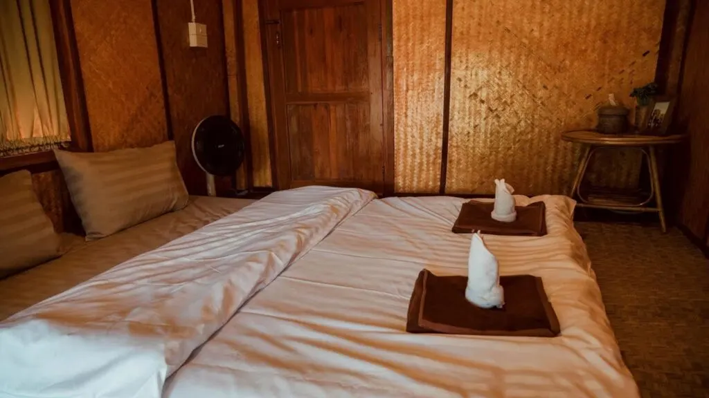 Chiang Mai tour homestay room with traditional bamboo walls and cozy bedding