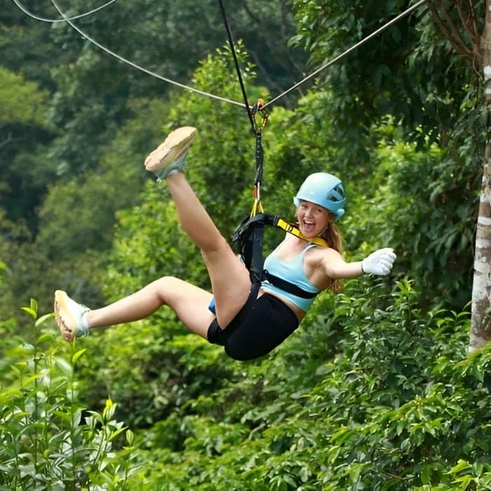Ziplining through lush forest canopy near Chiang Mai