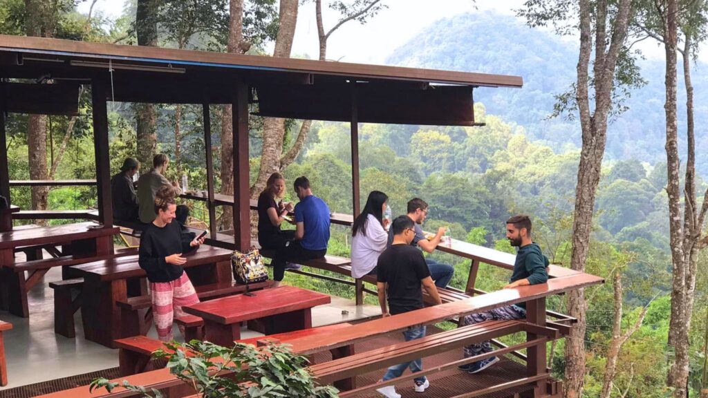 Tourists relaxing at a scenic viewpoint during a Zipline Chiangmai Go Tours excursion