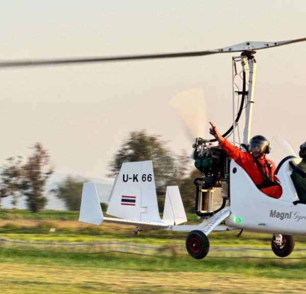 Tourist enjoying a thrilling paramotor flight over scenic landscapes during a Chiang Mai tour