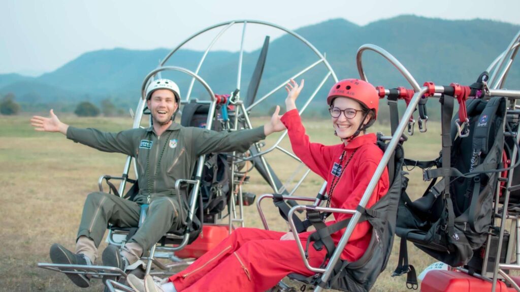 Tourists enjoying the anticipation of a thrilling paramotor ride in Chiang Mai excursions