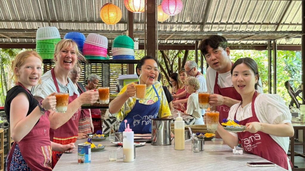 Participants savoring Thai iced tea, a refreshing break on a Chiang Mai tour.