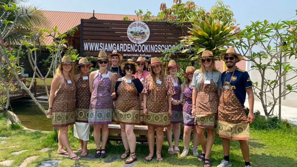 A group of tourists participating in a cooking class at Siam Garden Cooking