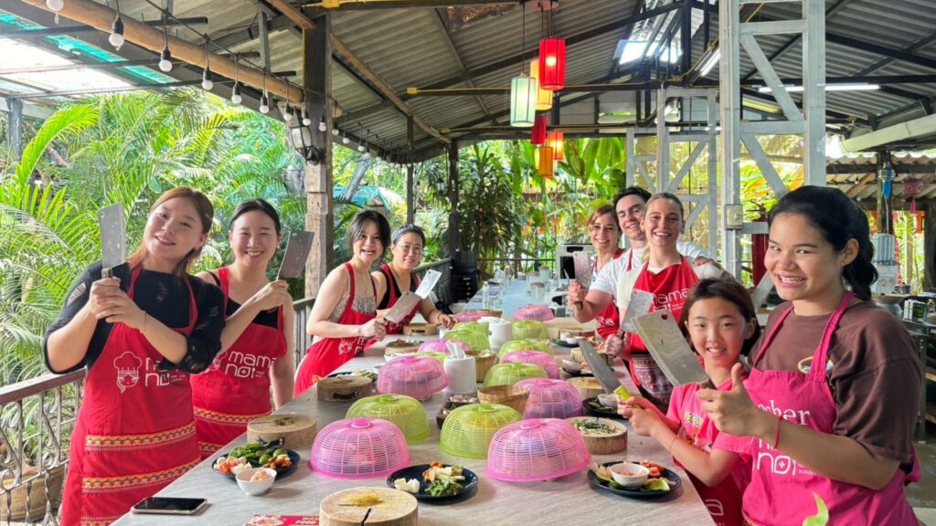 Participants in a Thai cooking class during a Chiang Mai tour, enjoying hands-on Chiang Mai excursions.