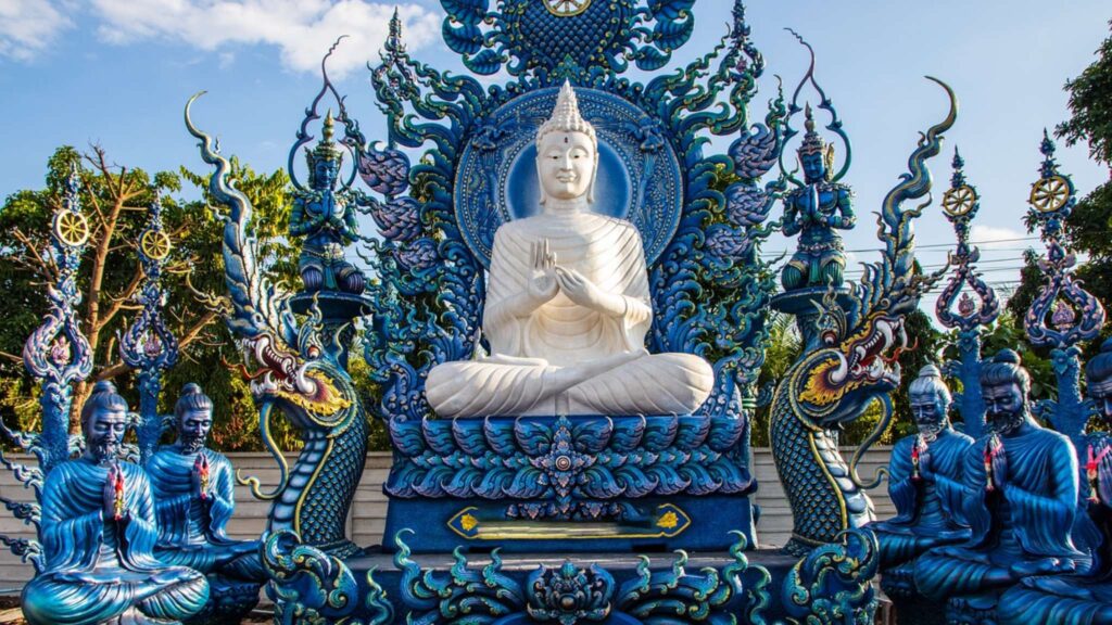 Magnificent white Buddha statue at Chiang Rai’s Blue Temple, featured in top Chiang Rai tours and temple excursions.