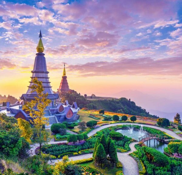 Twin Pagodas in Chiang Mai, perched on a mountain, offering panoramic views of the surrounding landscape and lush forests.