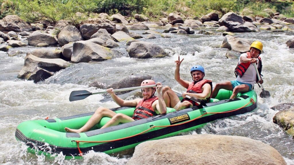 Thrilled traveler enjoying a fun rafting adventure on the river waters, part of an exciting Chiang Mai tour experience