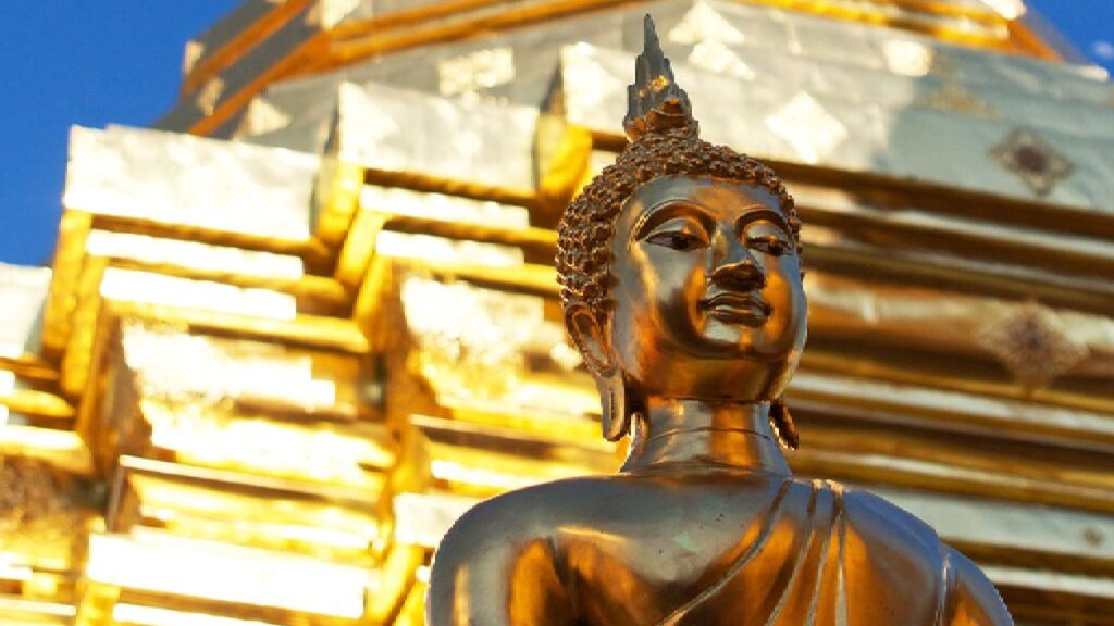 Close-up of the gold Buddhist statue at Doi Suthep Temple, a must-see attraction on a Chiang Mai tour.
