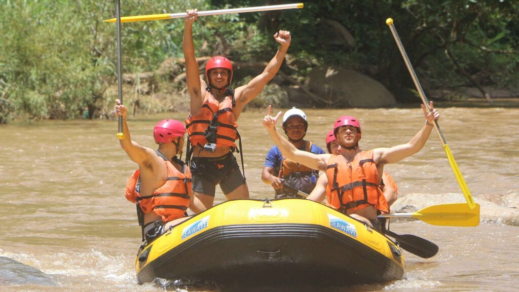 Group of travelers enjoying a white water rafting adventure in Chiang Mai, part of an exciting Chiang Mai tour and excursion