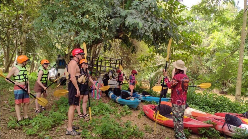 Group of tourists receiving kayaking instructions from a local guide on a Chiang Mai tour