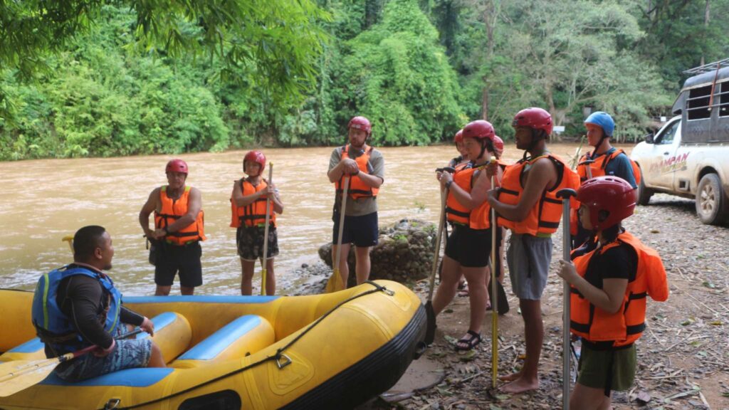 Rafting guide teaching safety tips to travelers during a Chiang Mai excursion