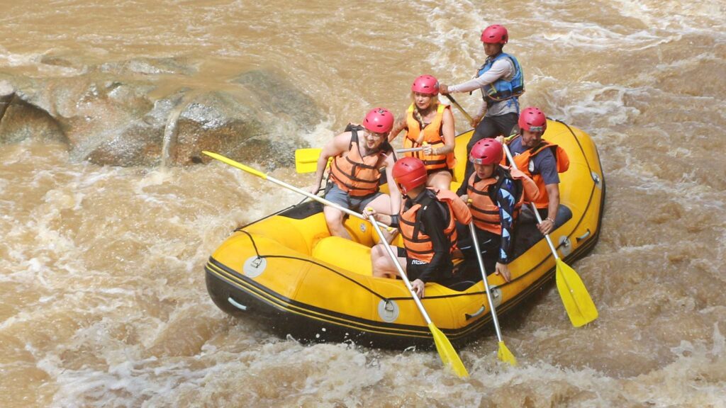 Travelers navigating the white water rapids on a Chiang Mai tour