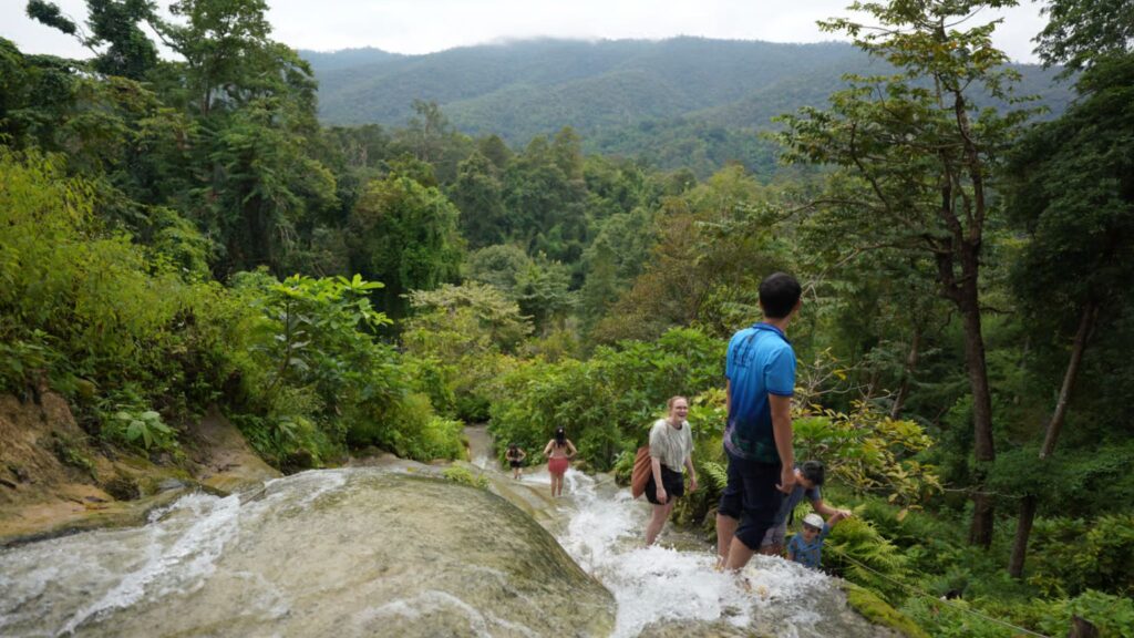 Traveler enjoying the climb at Chiang Mai’s famous Sticky Waterfall