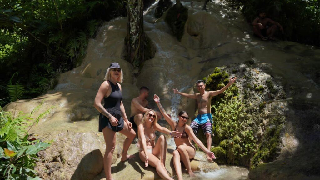 Visitors relaxing at the multi-level Sticky Waterfall during Chiang Mai tour