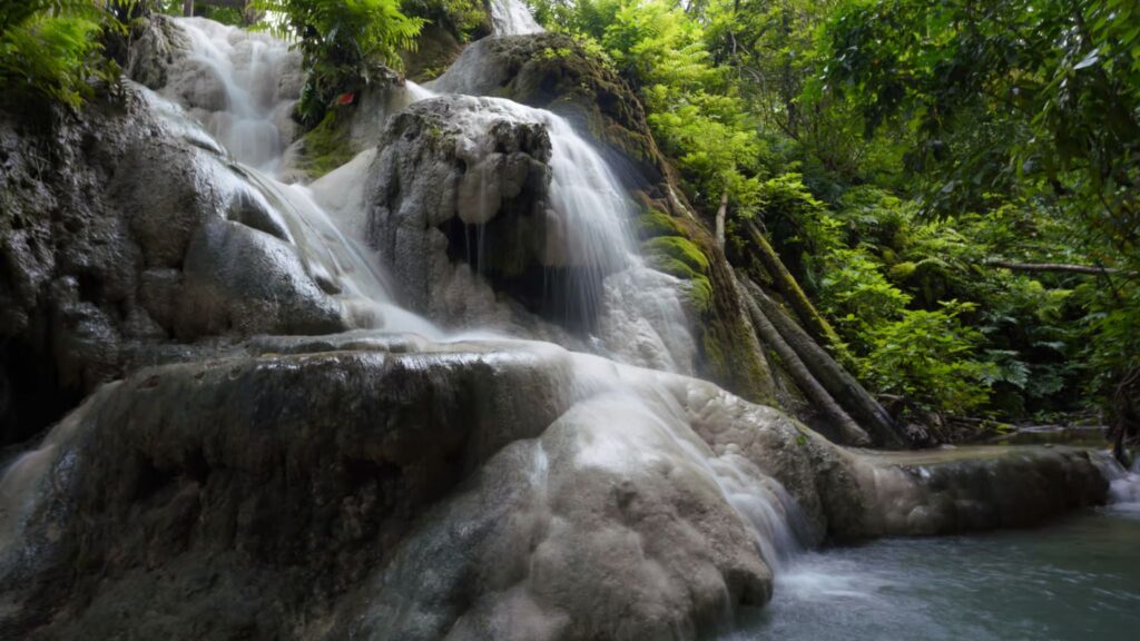 Bua Tong Sticky Waterfall with crystal-clear water and lush forest