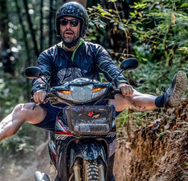A man riding a scooter off-road during a thrilling Chiang Mai scooter adventure, showcasing the excitement of exploring the city's rugged terrain.