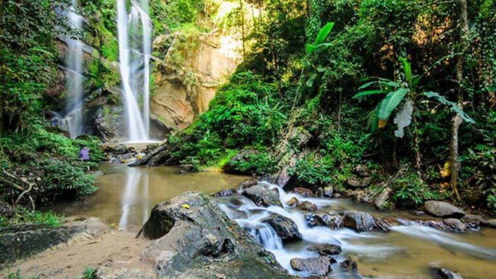 A stunning waterfall surrounded by lush greenery, a peaceful escape in northern Thailand.