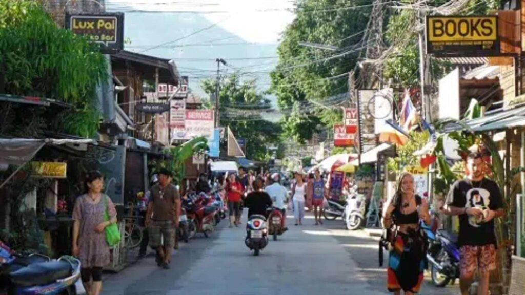 Tourists browsing through shops and enjoying the relaxed vibe of this northern Thai town.