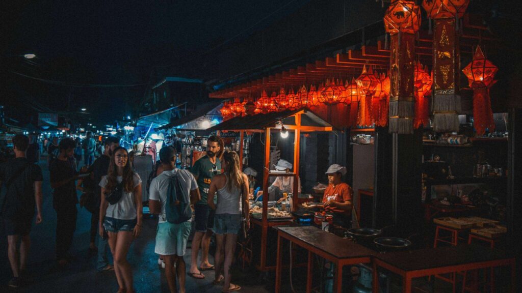 Bustling walking street in Pai, a must-visit destination when you travel from Chiang Mai to Pai, featuring local food, handicrafts, and a lively atmosphere.