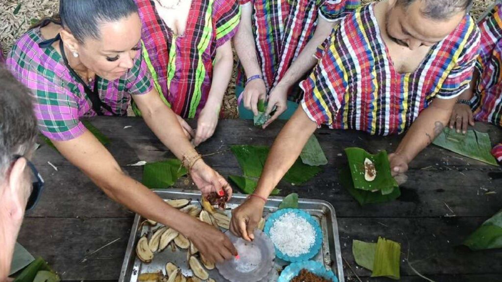 A group of visitors prepares elephant food during a Chiang Mai tour at an elephant