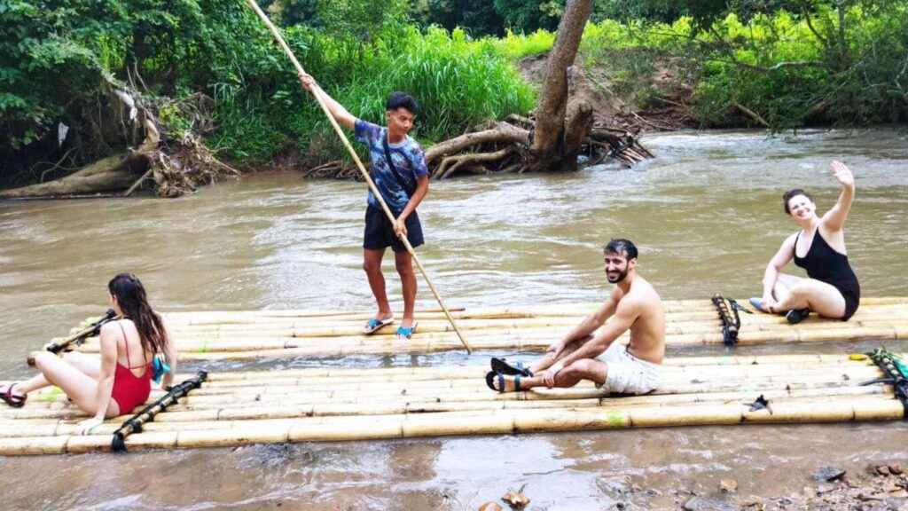 Exciting Chiang Mai excursion, as tourists go bamboo rafting with a local guide.