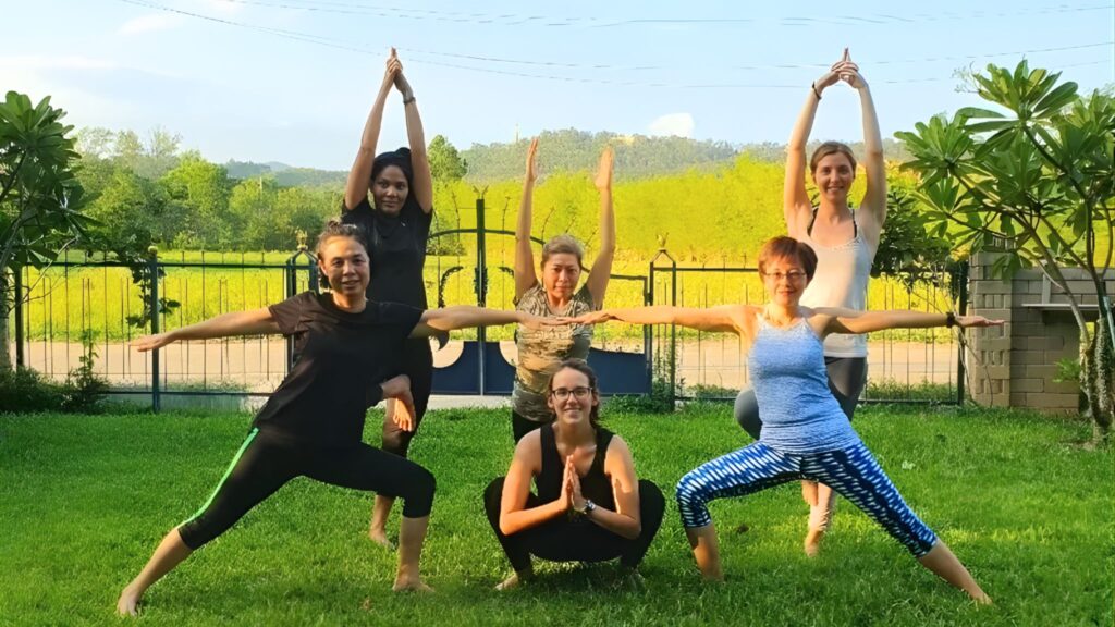 Participants stretching during a Chiang Mai wellness and yoga tour at a retreat center.