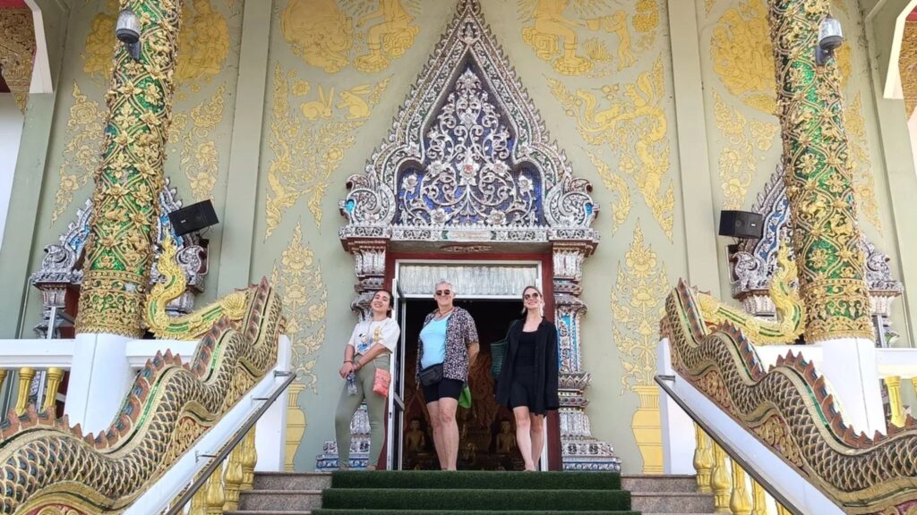 Group of retreat participants visiting a breathtaking Thai temple as part of a Chiang Mai cultural excursion