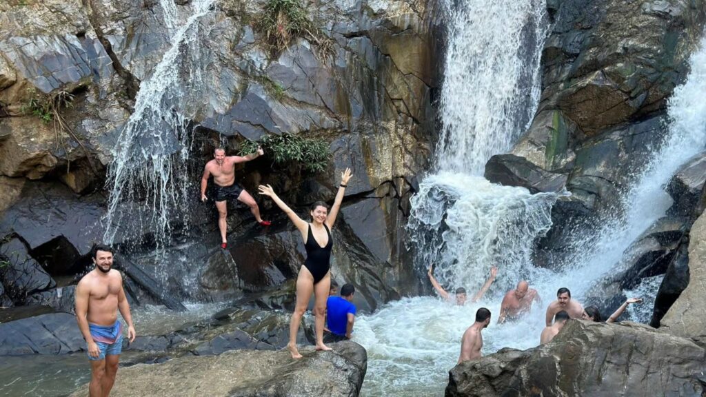 Visitors swimming at Mae Wang Waterfall on a Chiang Mai nature tour